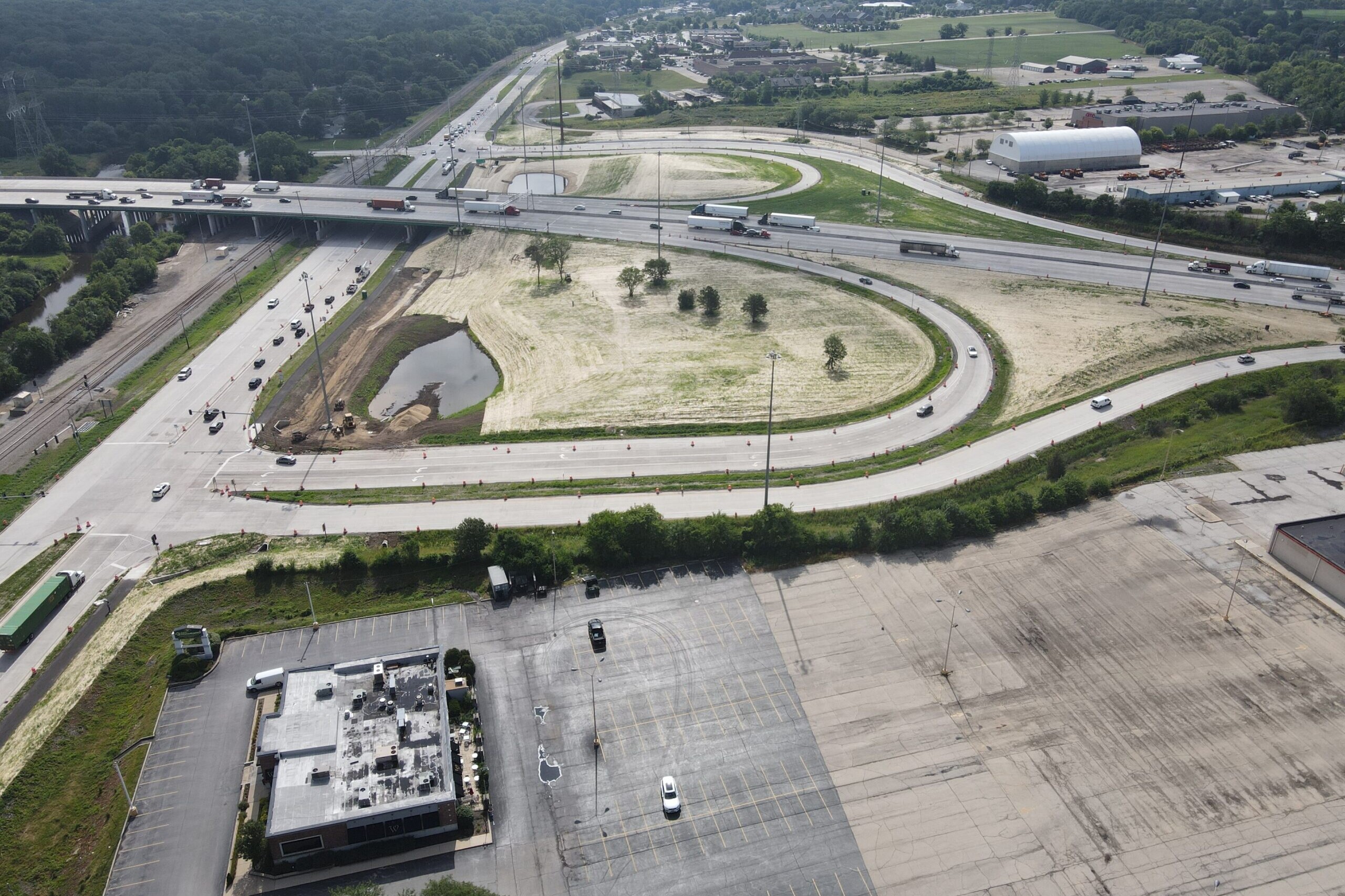 An aerial view of a parking lot and a highway.