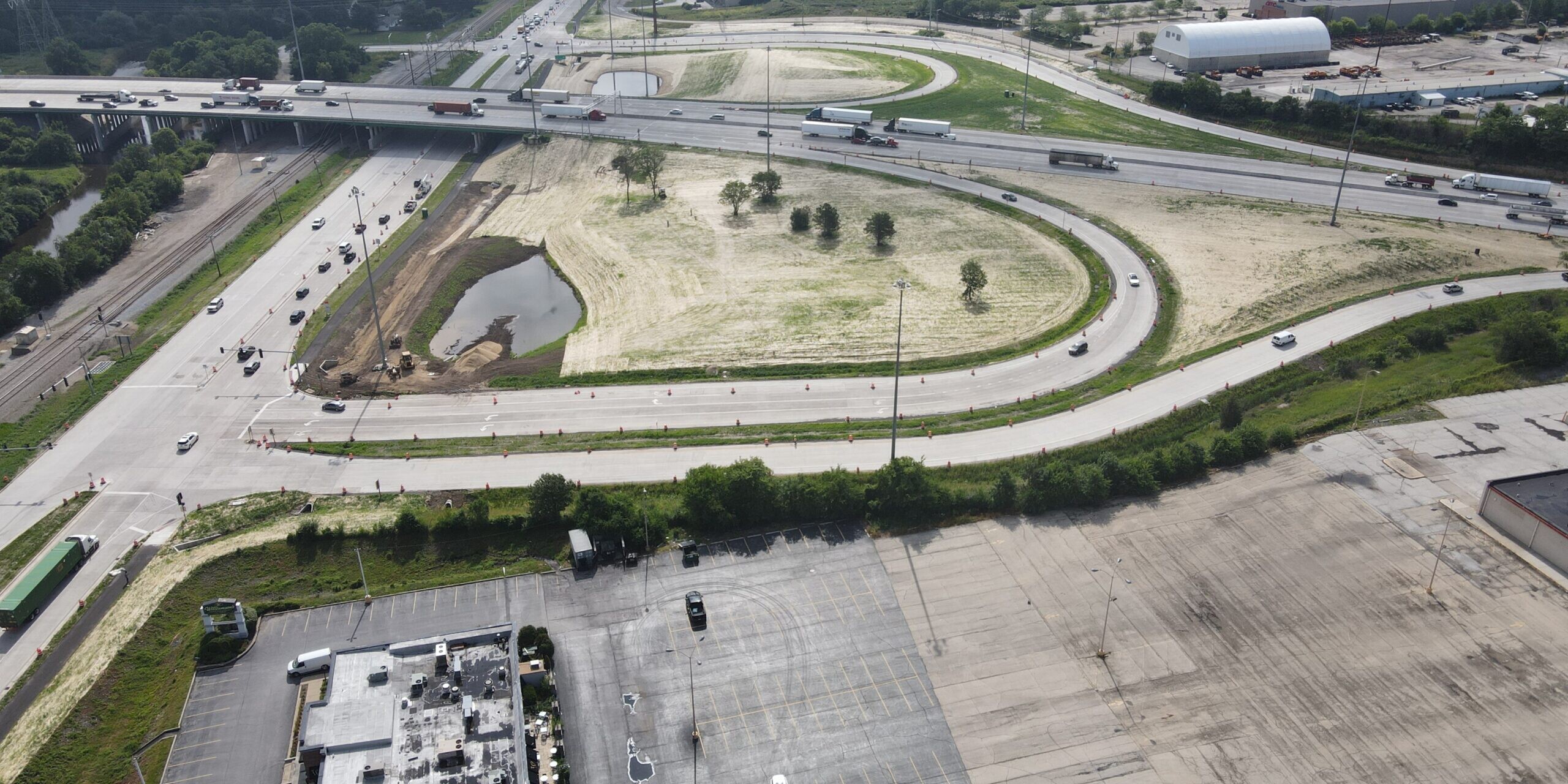 An aerial view of a parking lot and a highway.