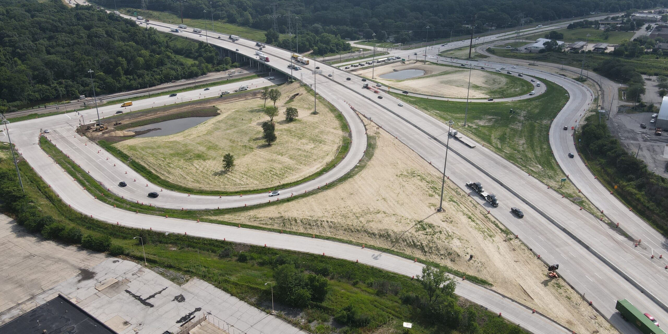 An aerial view of a highway with lots of trees.