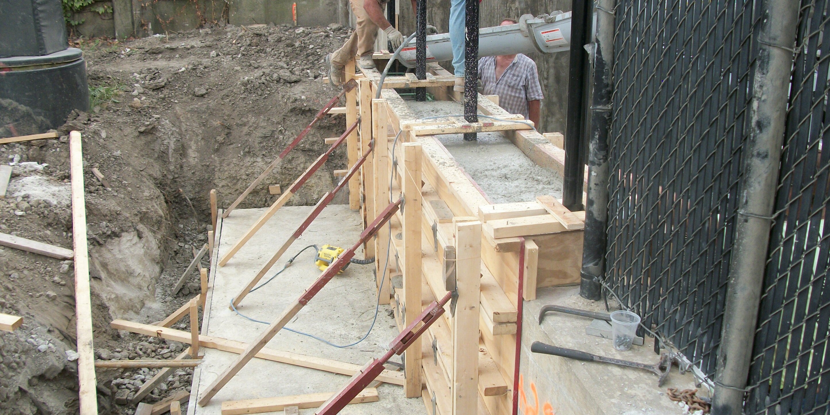 A group of people working on the side of a building.