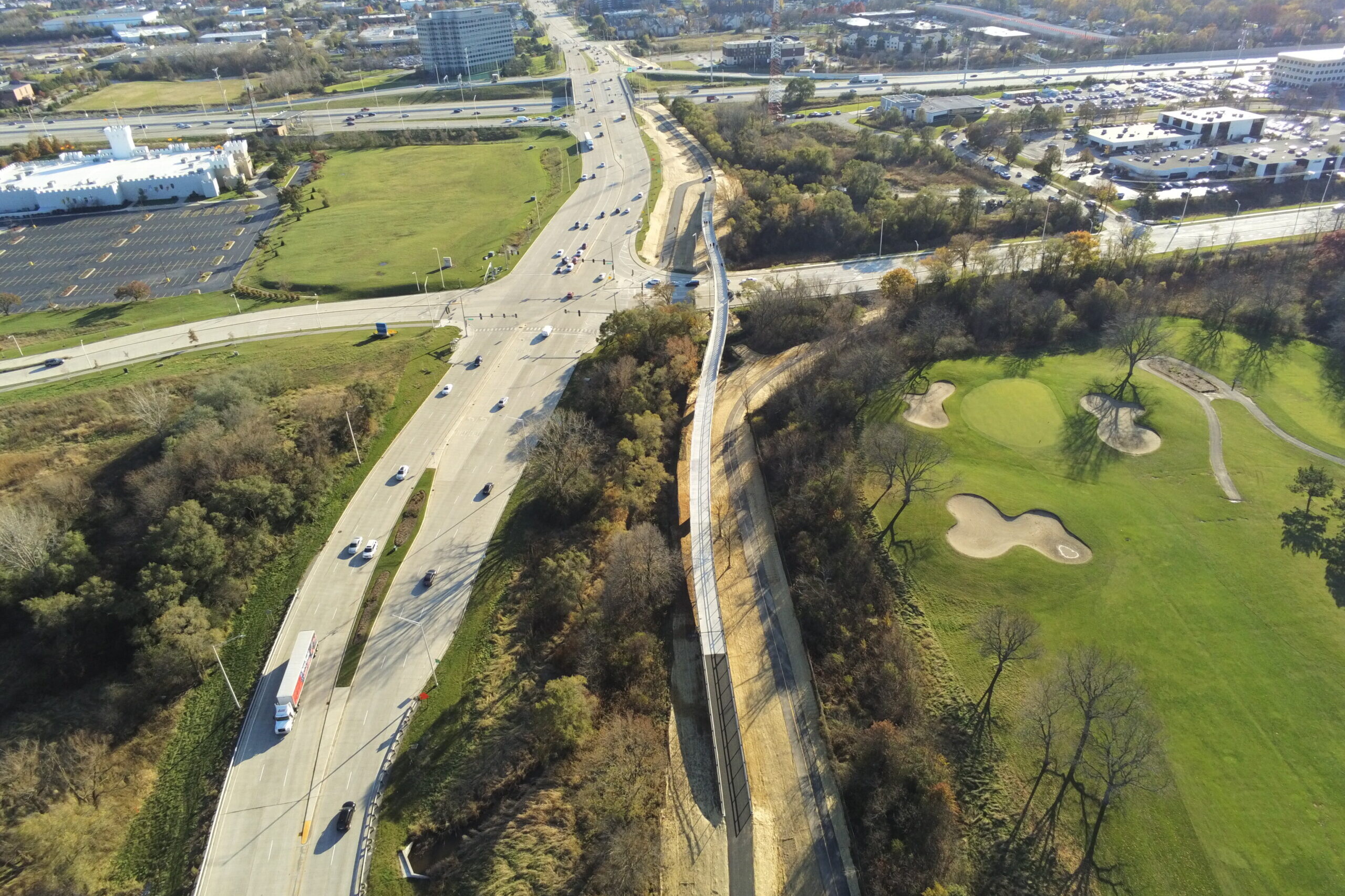 An aerial view of a highway with cars driving on it.