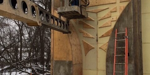 A man is working on the side of a building.