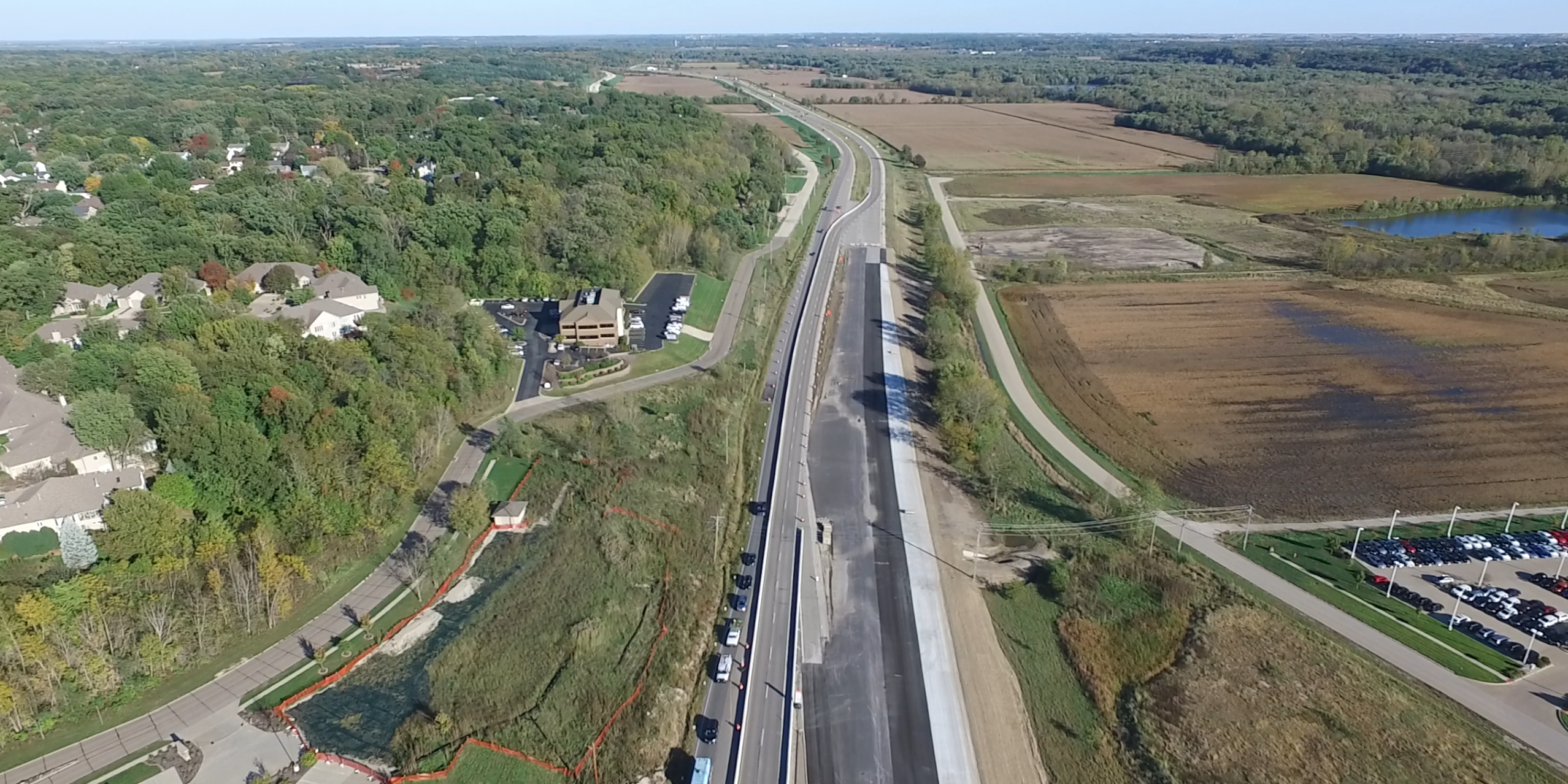 An aerial view of a highway with cars driving on it.