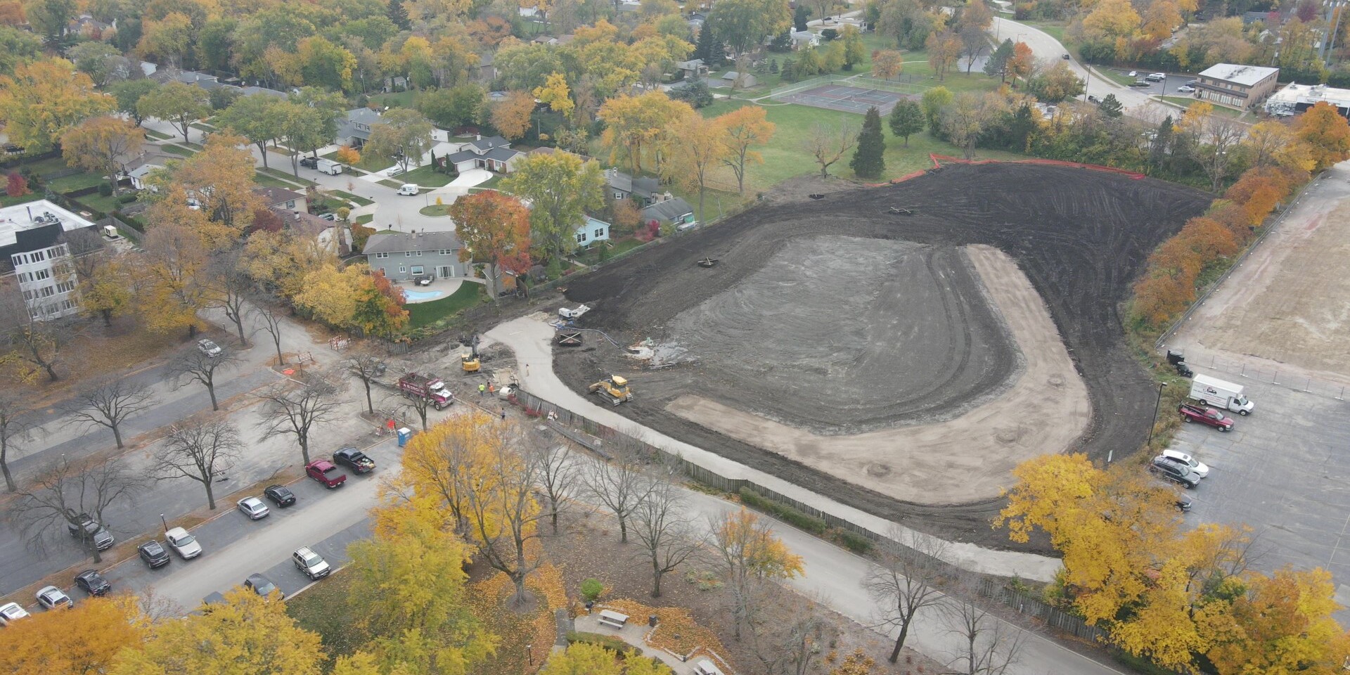 A view of an area with trees and dirt.