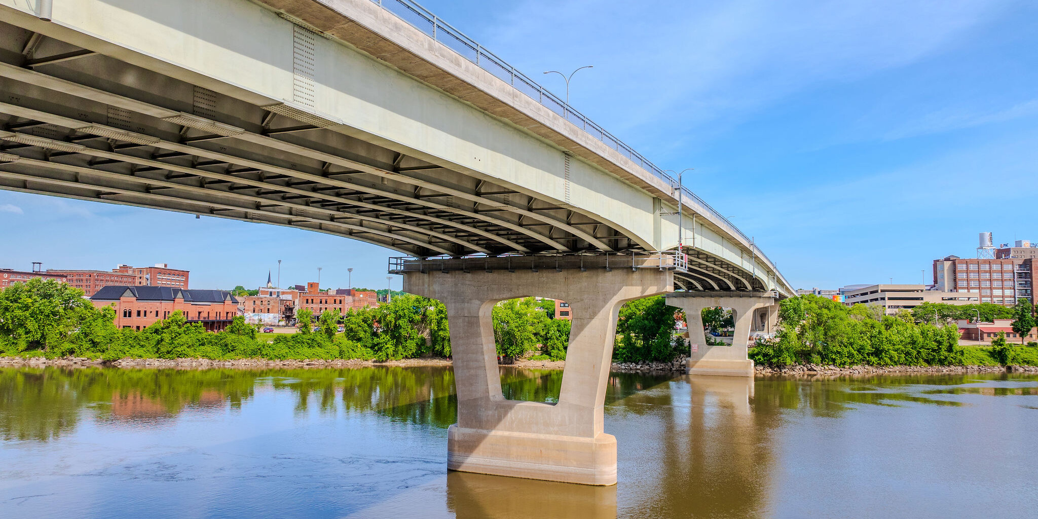 A bridge over water with trees in the background