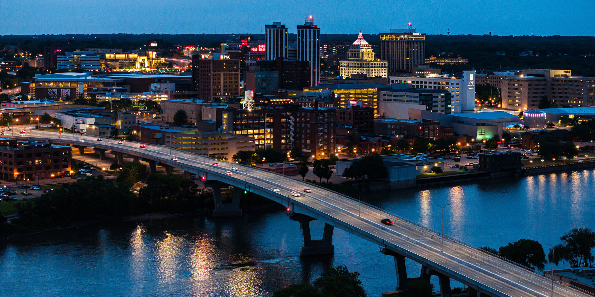 A city skyline with a bridge over the water.