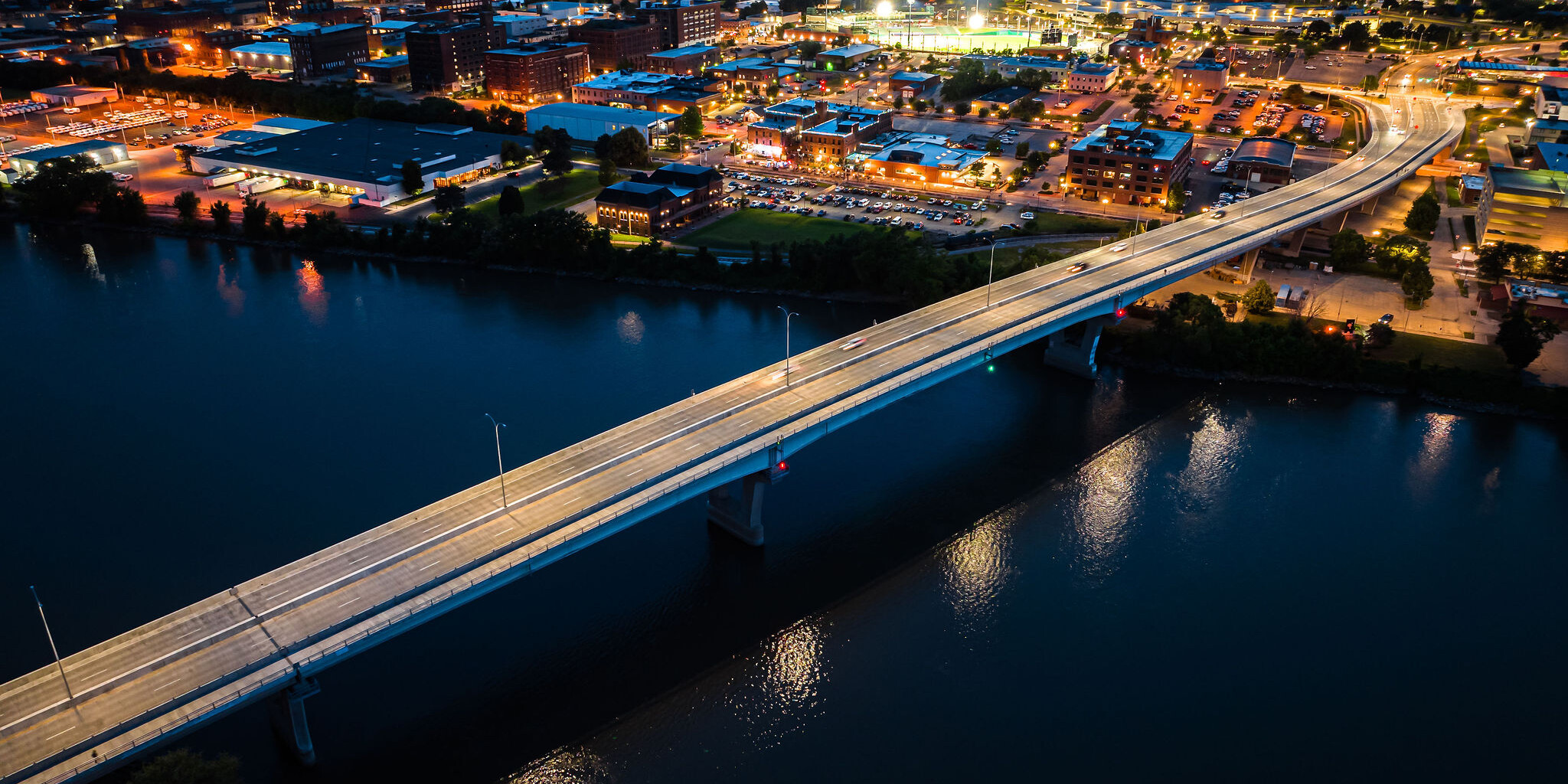 A bridge over water with lights on it.