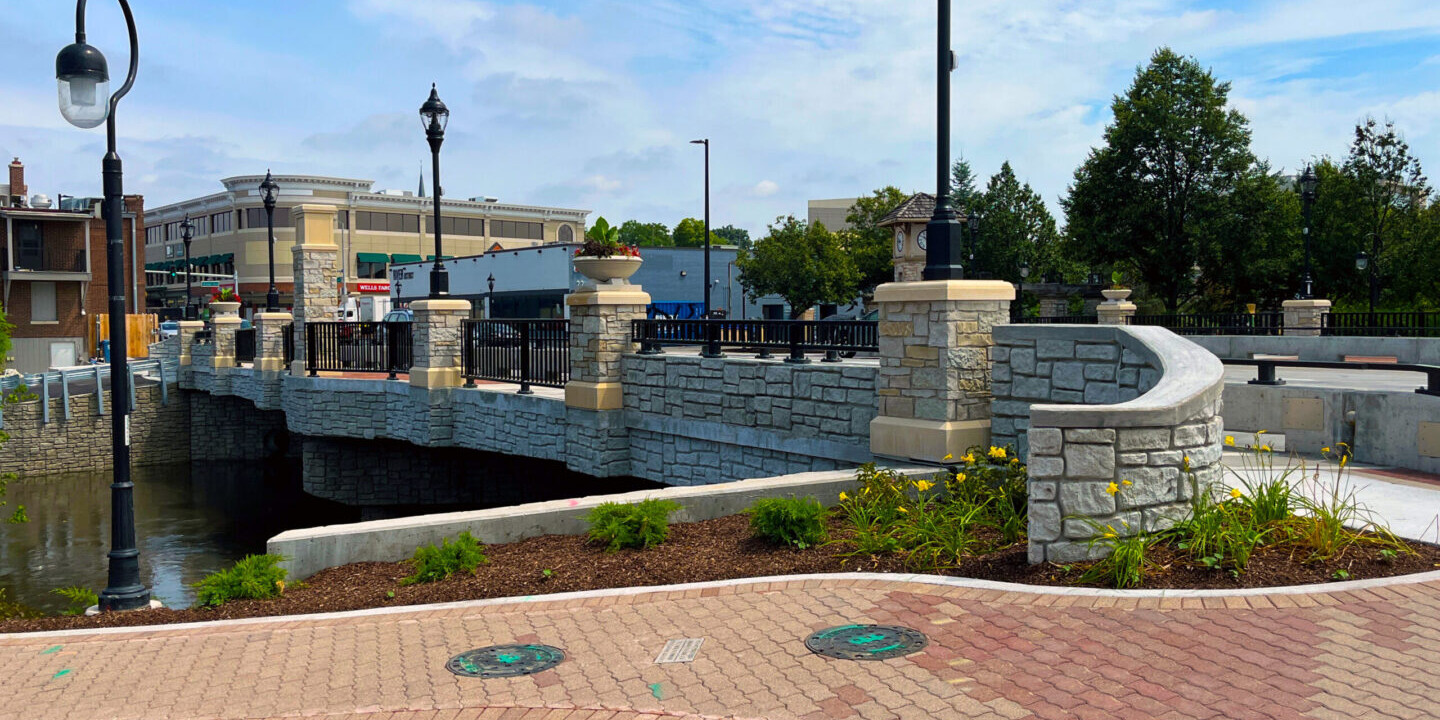 Stone bridge with lampposts and clock tower