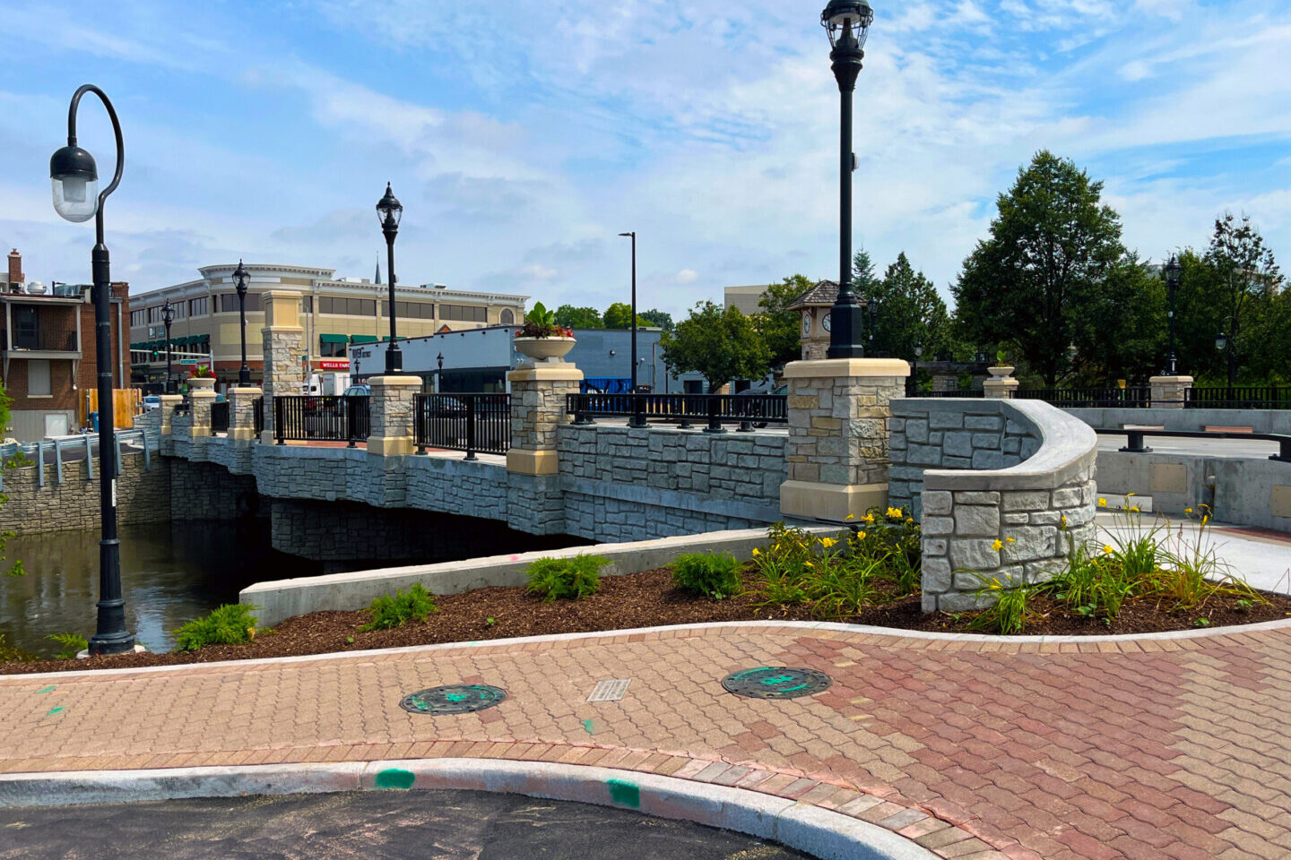 Stone bridge with lampposts and clock tower